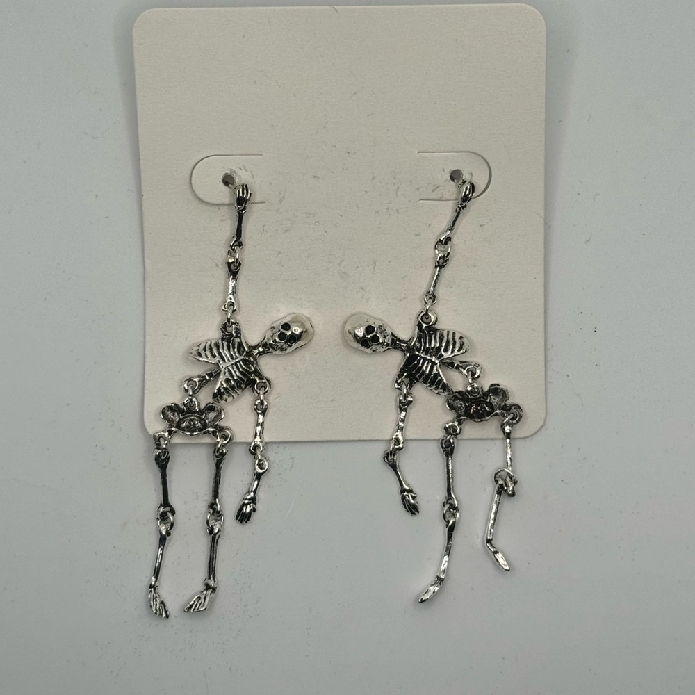 “Barely Hanging On” Skeleton earrings NWOT